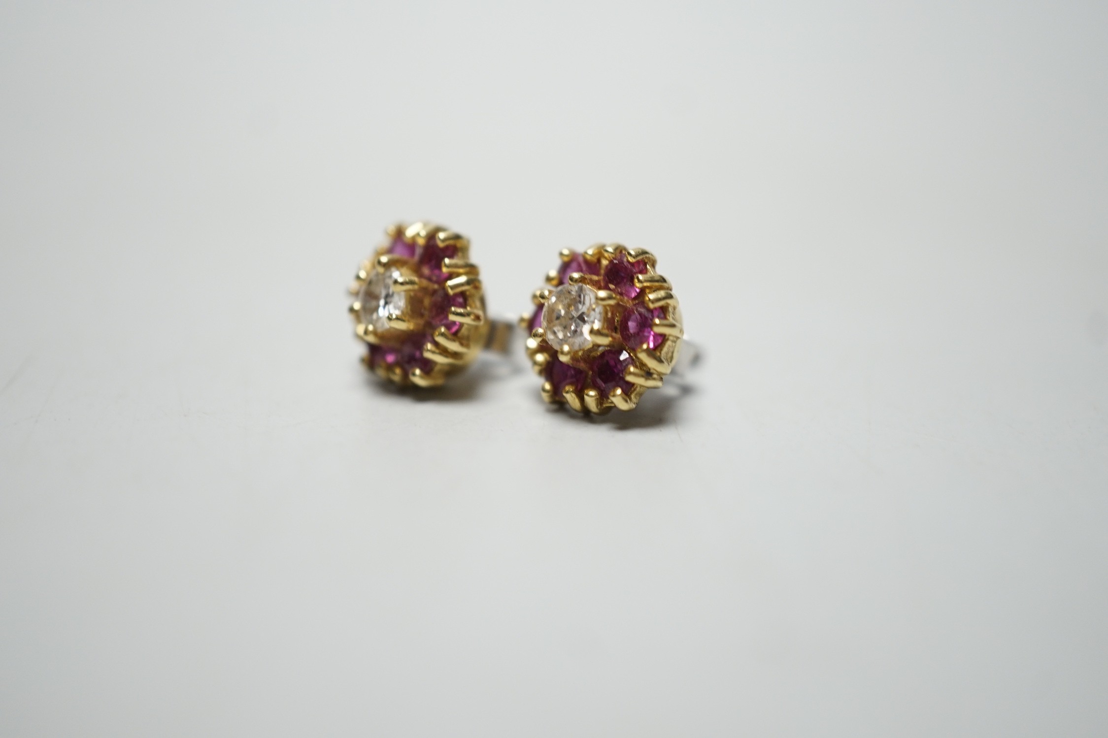 A pair of 18ct gold, diamond and garnet? circular cluster ear studs, 9mm, gross weight 4 grams.